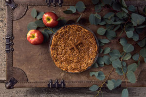 Delicious Caramel Apple Pie with apples and greenery